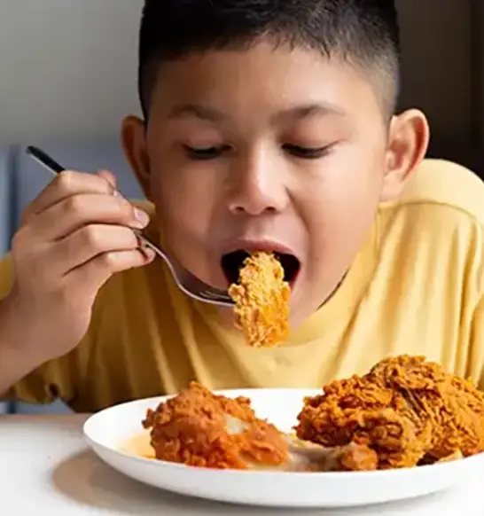 boy-eating-fried-chicken-website-height.webp